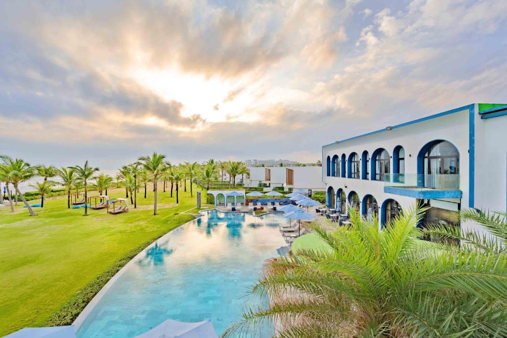 an aerial view of a resort with a swimming pool at Aqua Vista Hoi An Beachfront Villas in Dien Ban