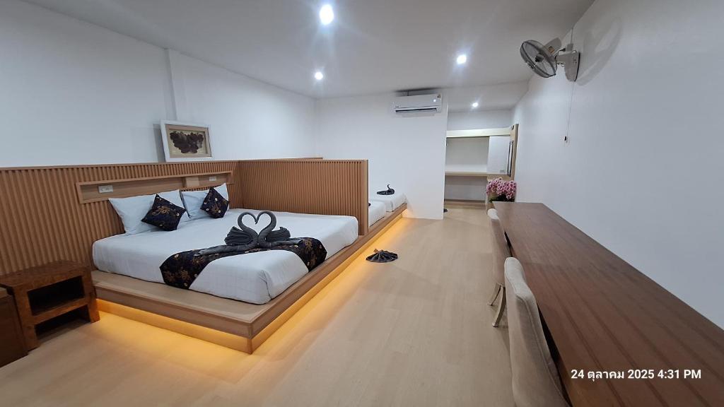 a bedroom with a bed with a black bow on it at Sleep In Lanta Resort in Ko Lanta