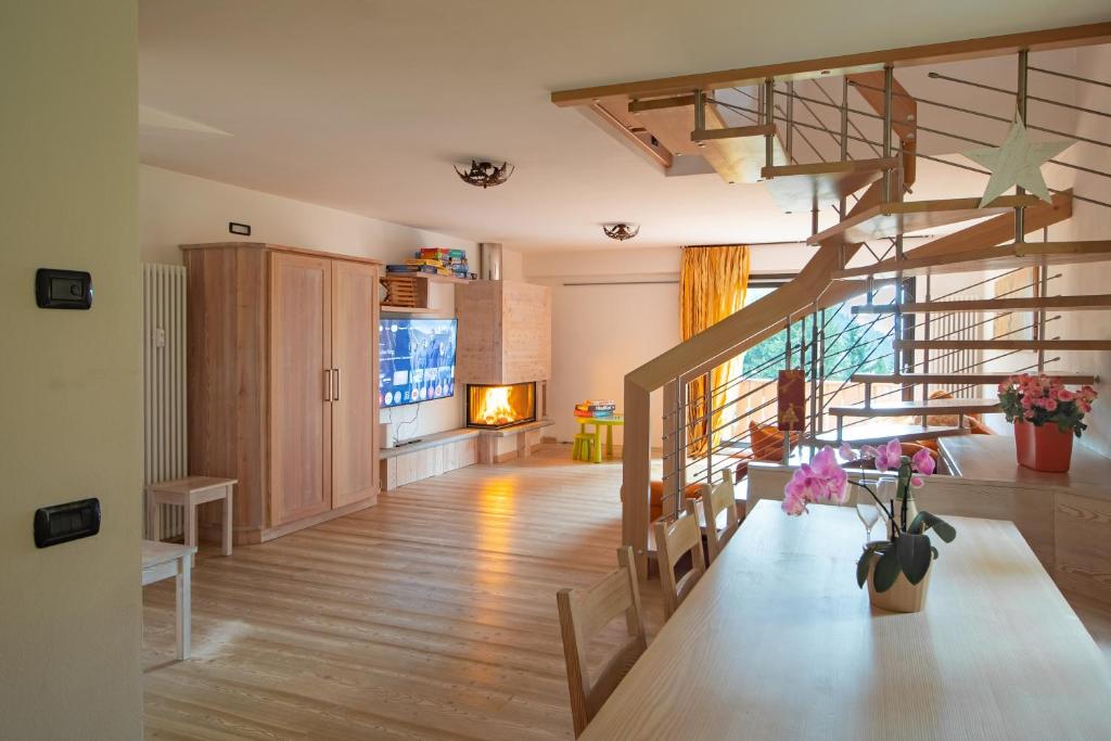 a living room with a spiral staircase in a house at CAMPIGLIO Panorama sul Brenta in Madonna di Campiglio