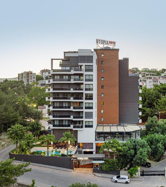 a large building with a pool in front of it at Utopia Suite Residence1 in Burunabat