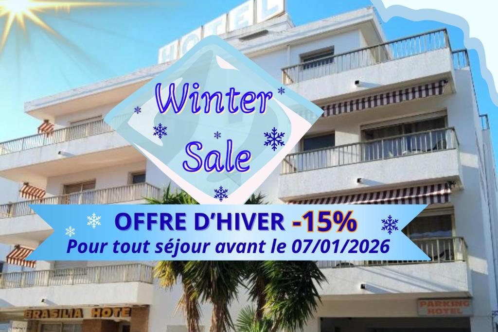 a winter sale sign in front of a building at Hôtel Restaurant Brasilia in Cagnes-sur-Mer
