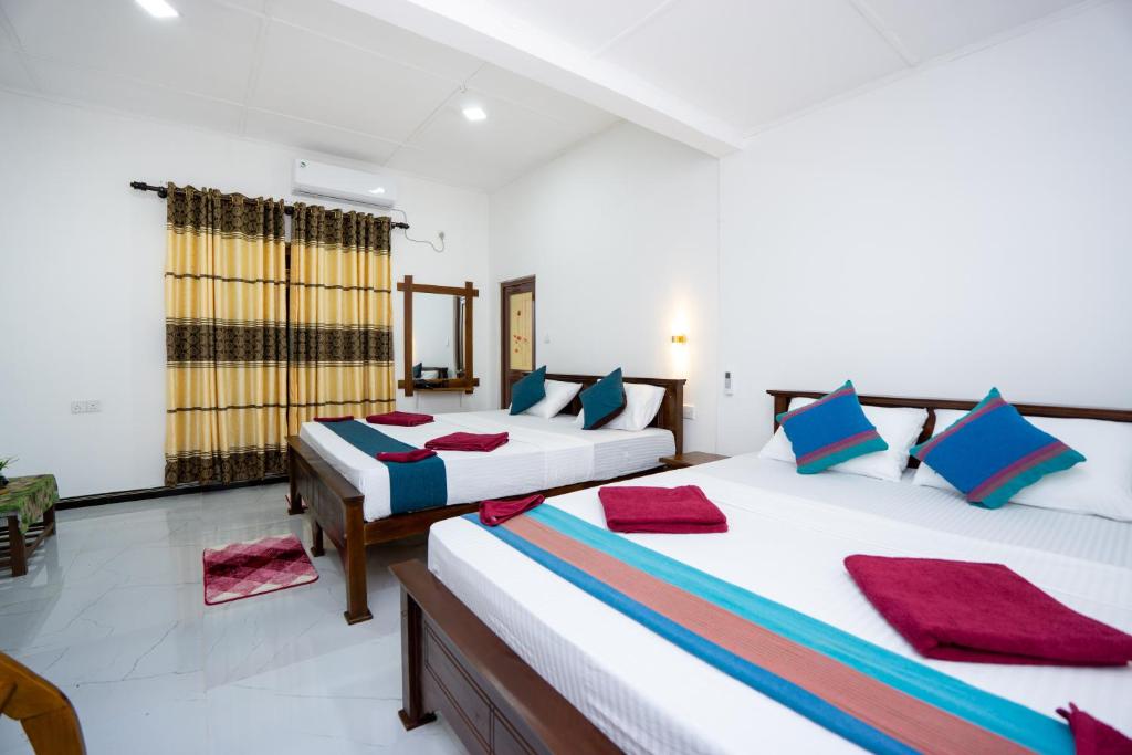 Ένα ή περισσότερα κρεβάτια σε δωμάτιο στο Sigiri Star Homestay