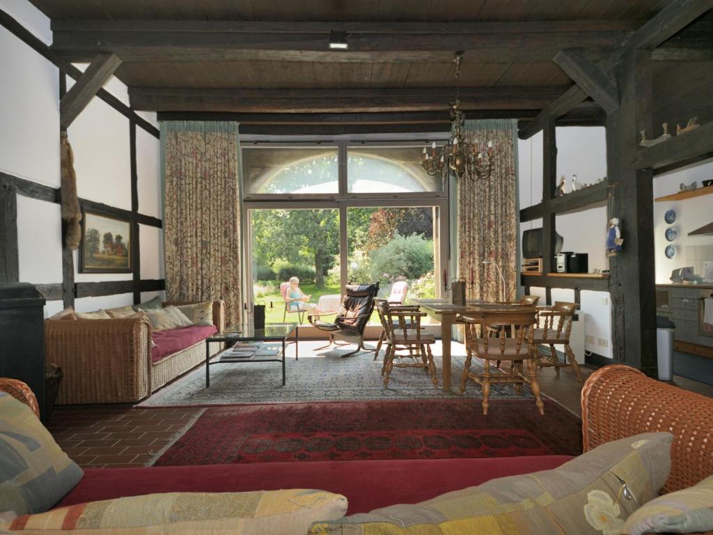 a living room with a table and chairs and a large window at Deelenwohnung in Trebel
