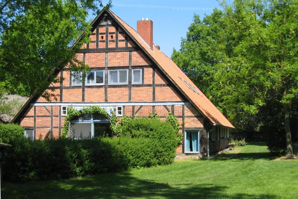 a large brick house with a gambrel roof at Schwalbennest in Trebel