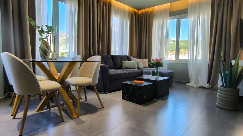 a living room with a table and a couch at Despoina Luxury Suites Xanthi in Xanthi