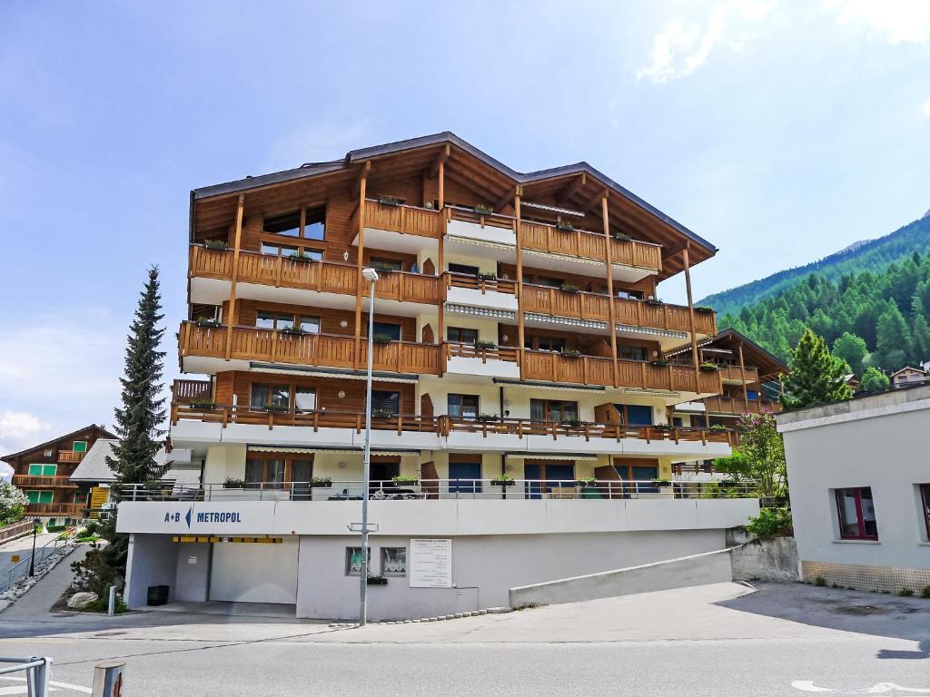 a large apartment building with a large balcony at Apartment Metropol B by Interhome in Grächen