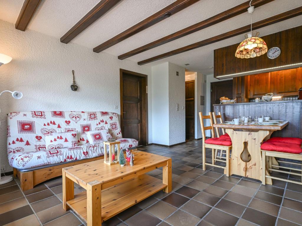 a living room with a couch and a table at Apartment Centaure B 103 by Interhome in Ovronnaz