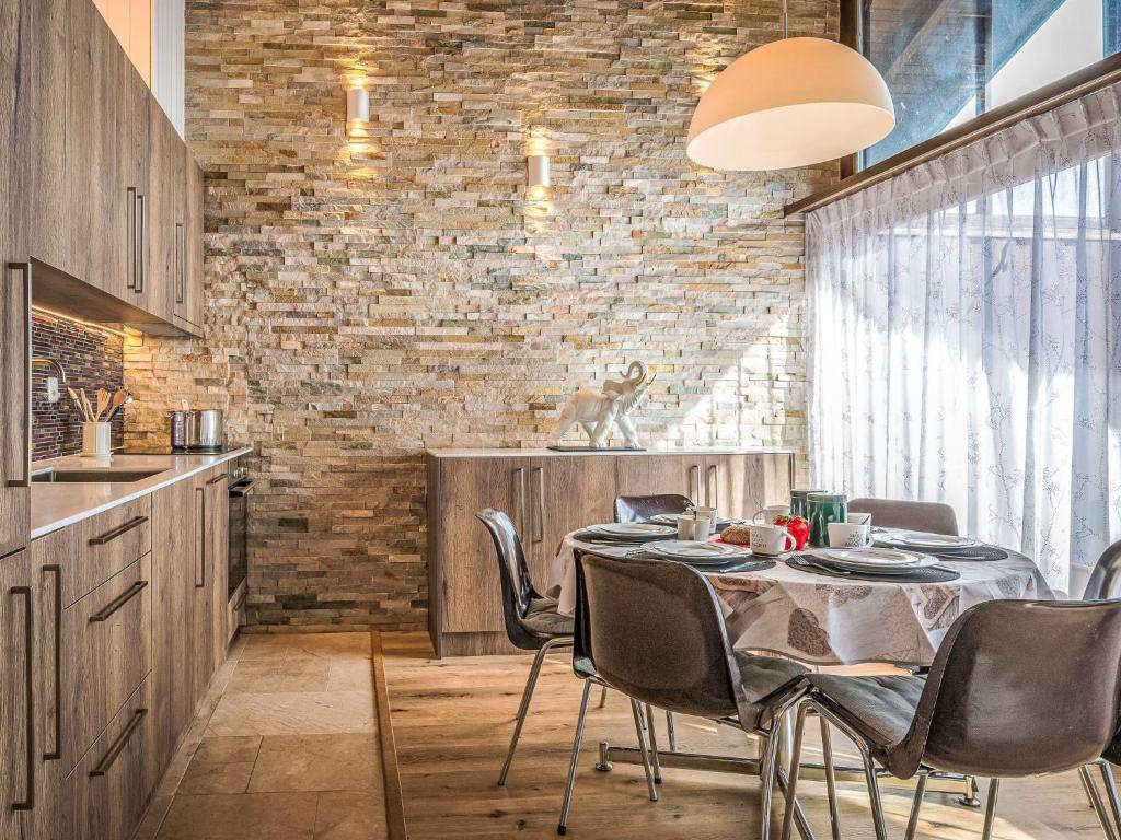 a kitchen and dining room with a table and chairs at Apartment Centaure B CO 1 by Interhome in Ovronnaz