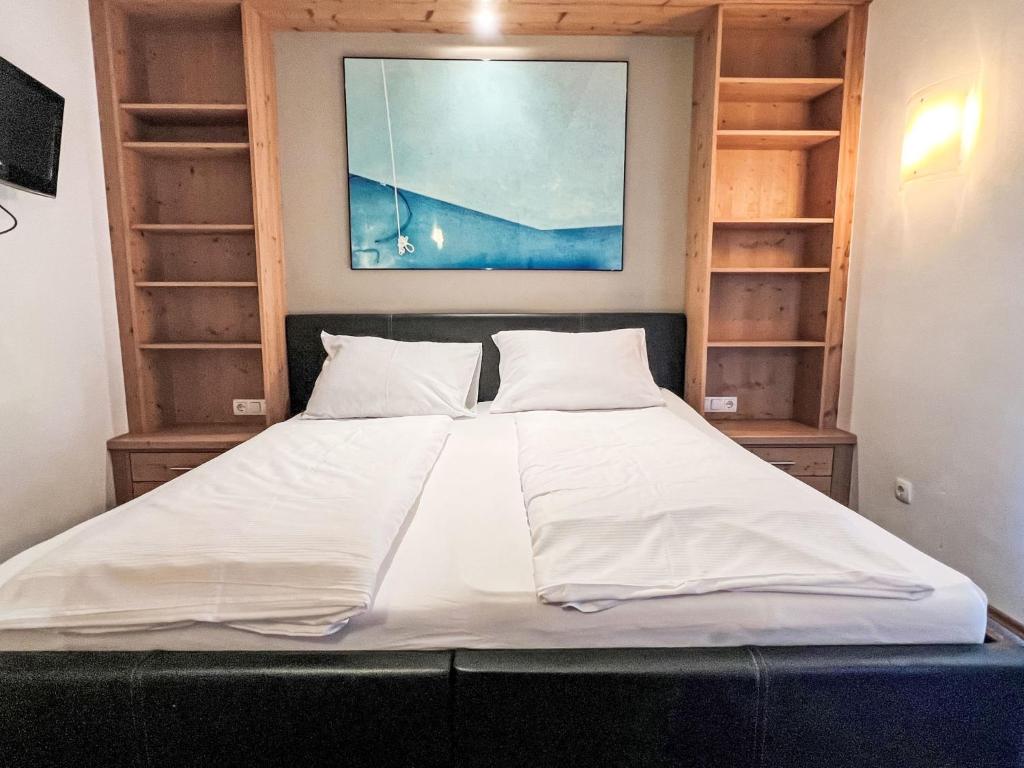 a large bed in a room with wooden shelves at Apartment Cheeky Apartment-5 by Interhome in Oberndorf in Tirol
