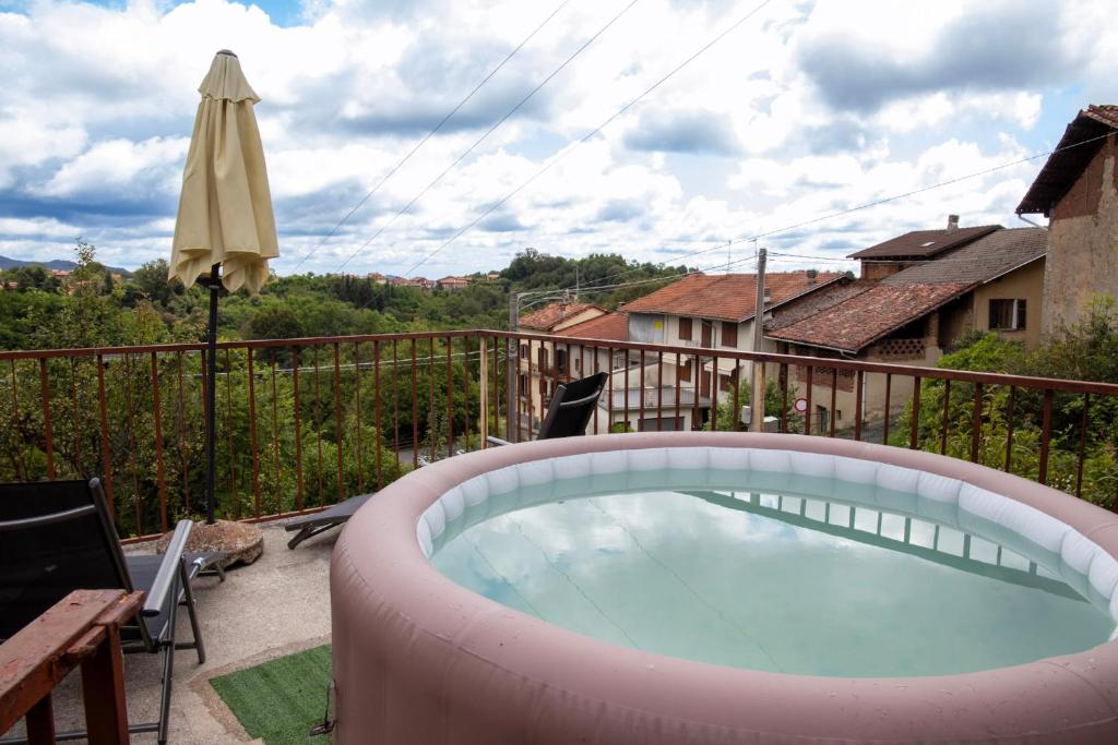 a large plunge pool on a balcony with an umbrella at Ca' Dij Noni in Strona