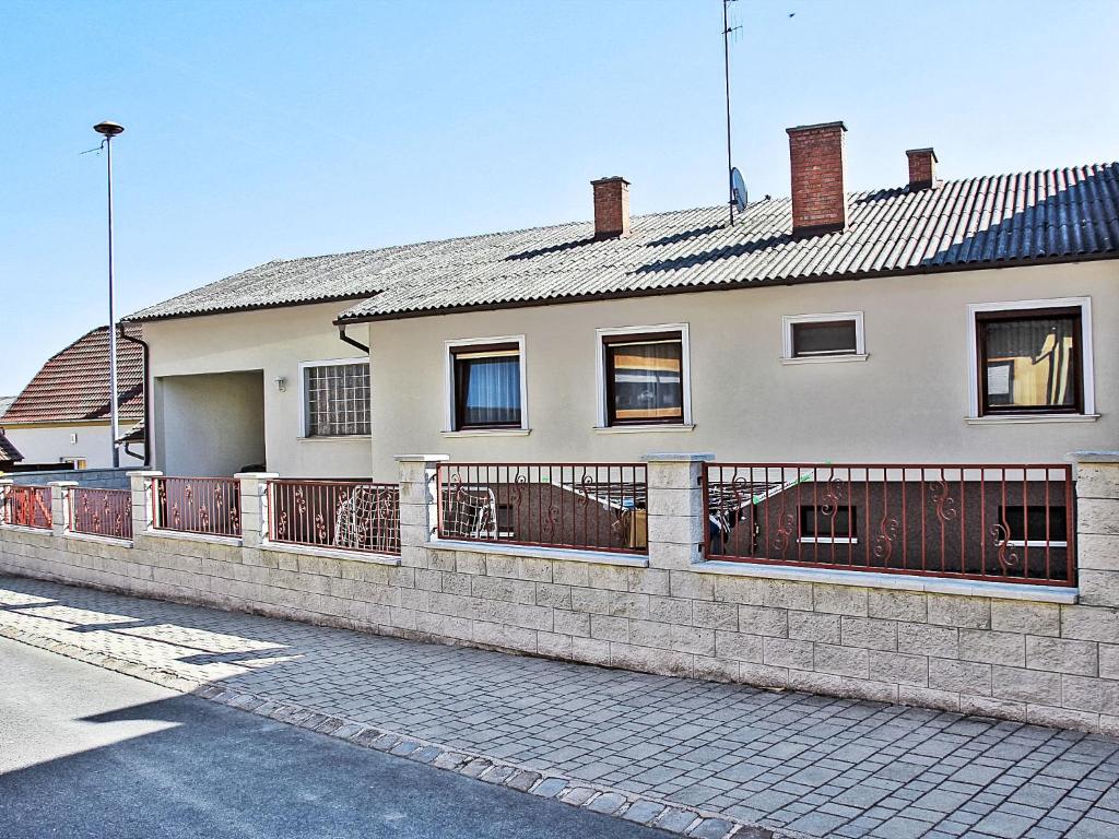 a house with a fence in front of it at Holiday Home Pannonia by Interhome in Unterfrauenhaid