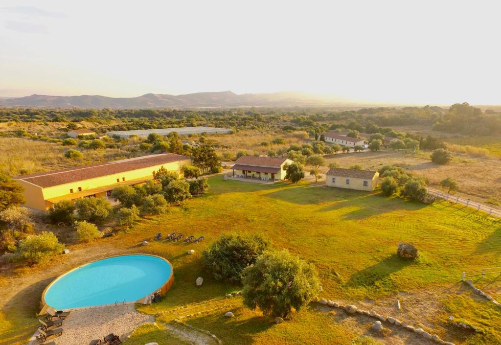 an aerial view of a house with a pool in a field at ISA - Lofts with private outdoor area and swimming-pool in Badesi in Badesi