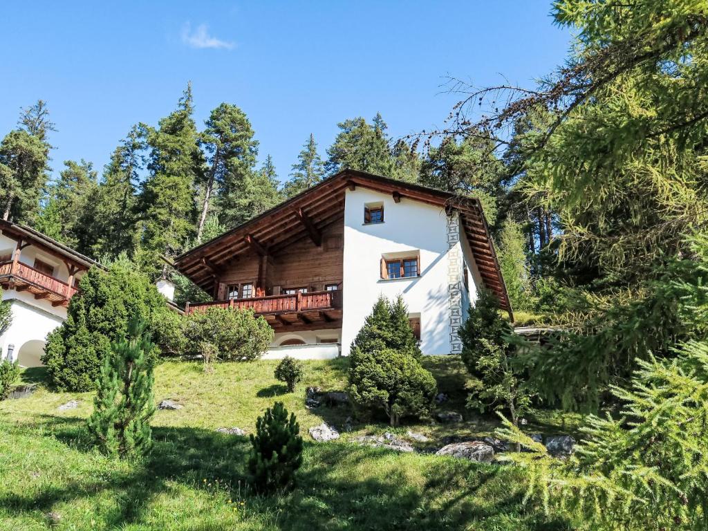 a house in the woods with a balcony at Chalet Spunda Biala by Interhome in Laax