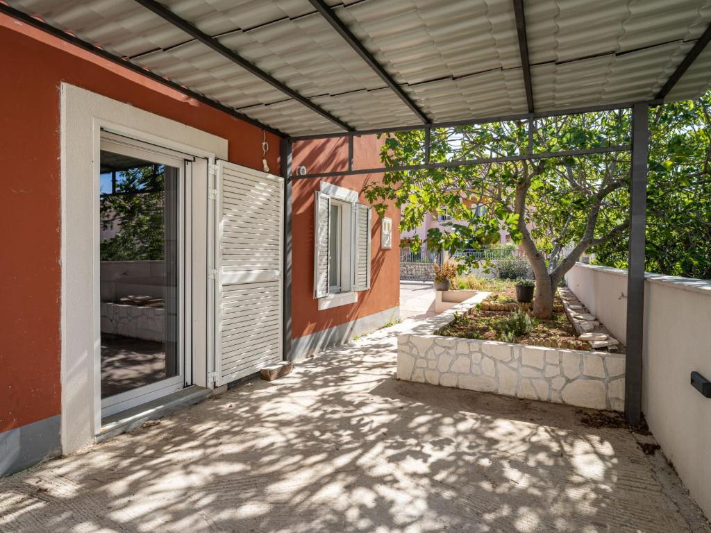 a patio with an open door and a tree at Holiday Home Ivanica by Interhome in Zablaće