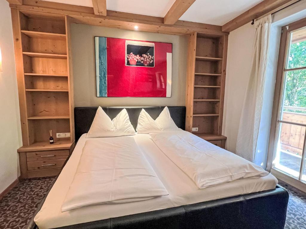 a large white bed in a room with shelves at Apartment Cheeky Apartment-1 by Interhome in Oberndorf in Tirol