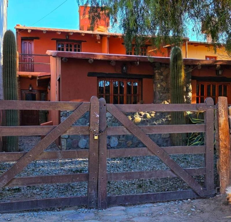 a wooden gate in front of a house at Tierra Norte in Tilcara