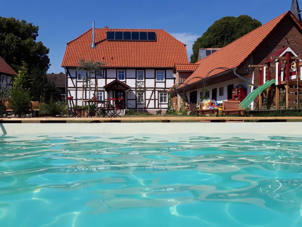 a house with a swimming pool in front at Landhaus Weserbergland in Vahlbruch