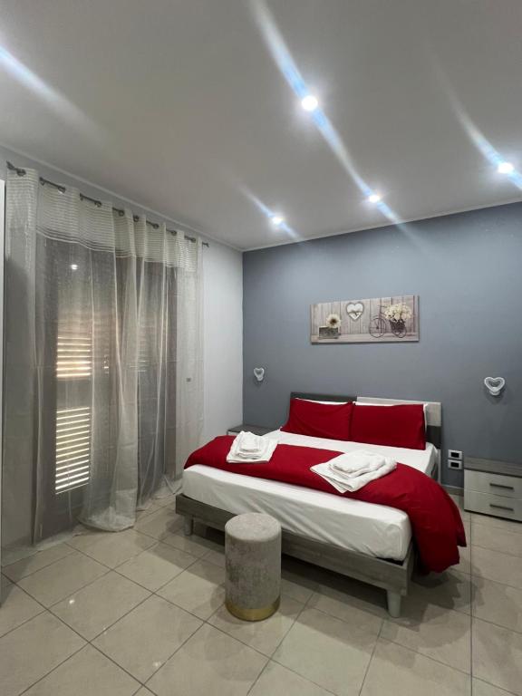a bedroom with a large bed with red pillows at Incanto B&B in Reggio Calabria
