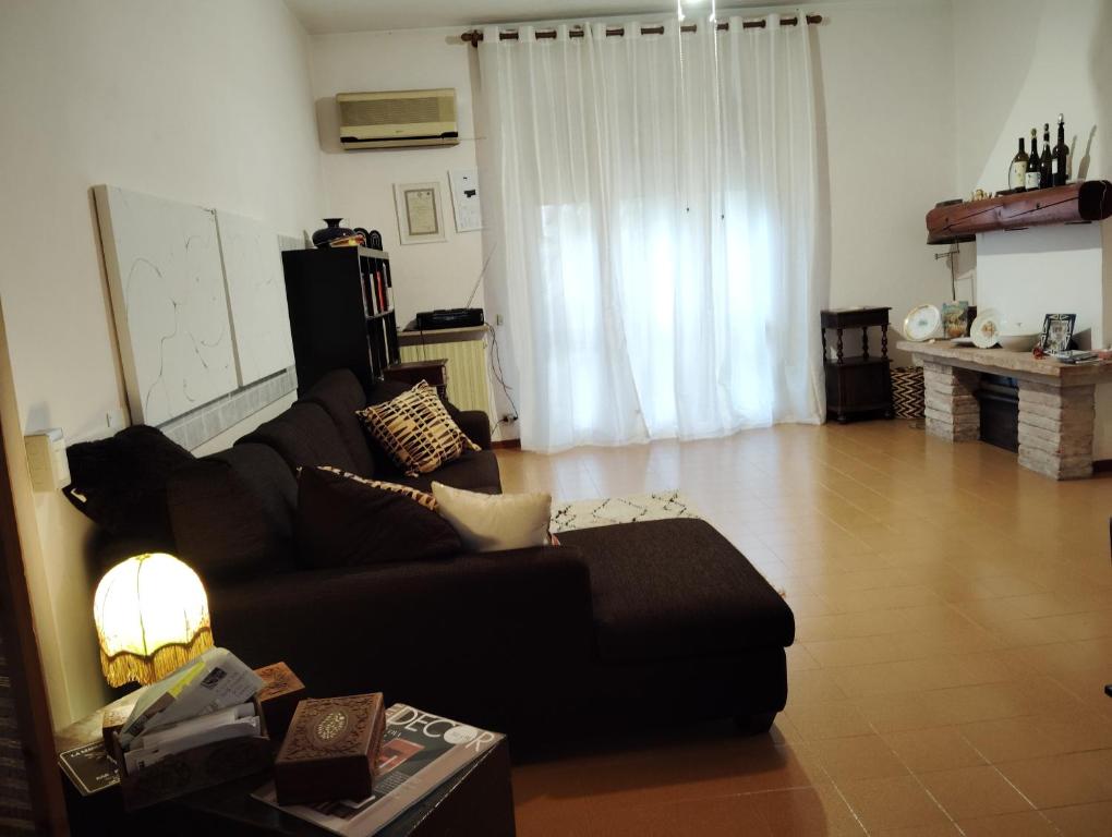 a living room with a couch and a table at Room Bed Bike in Berra