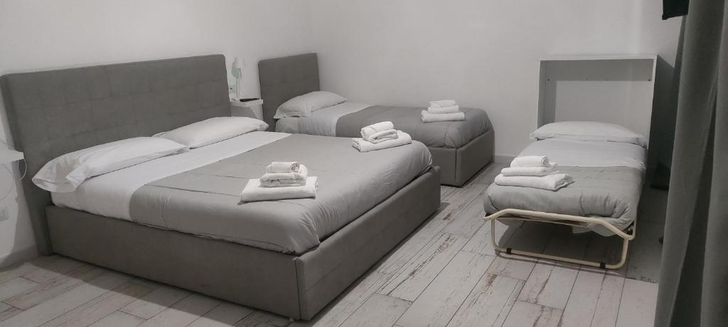 a bedroom with two beds with towels on them at Maison appartaments in Bari