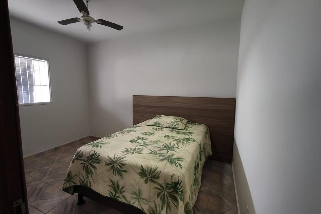 a bedroom with a bed and a ceiling fan at Casa Mar in Serra