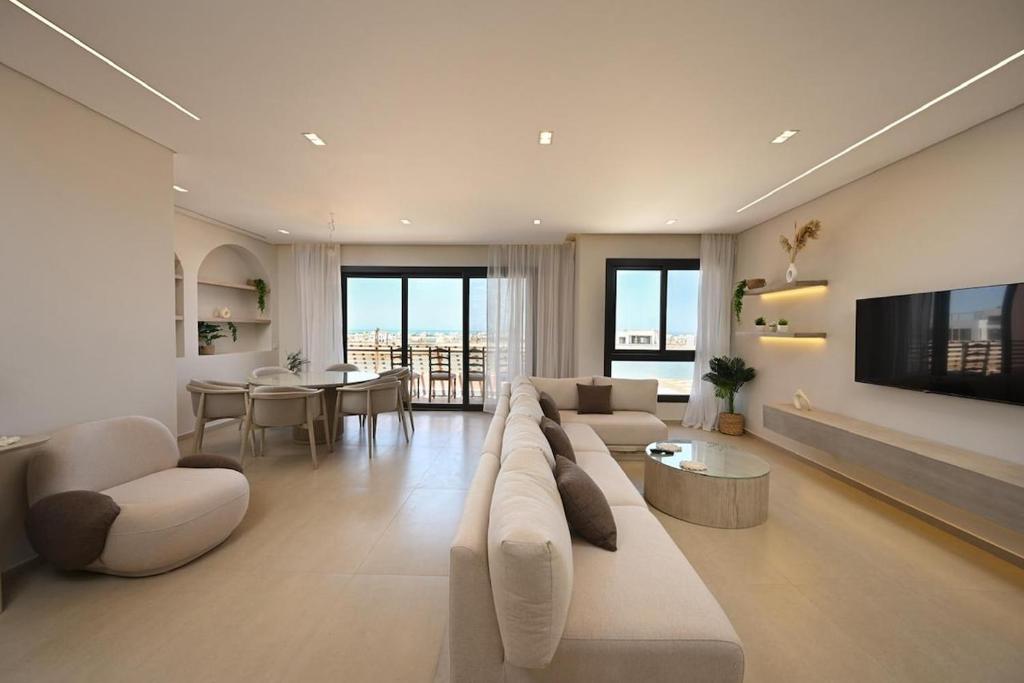 a large living room with a couch and a tv at Stunning 3 bd penthouse with private pool - El Gouna in El Gouna