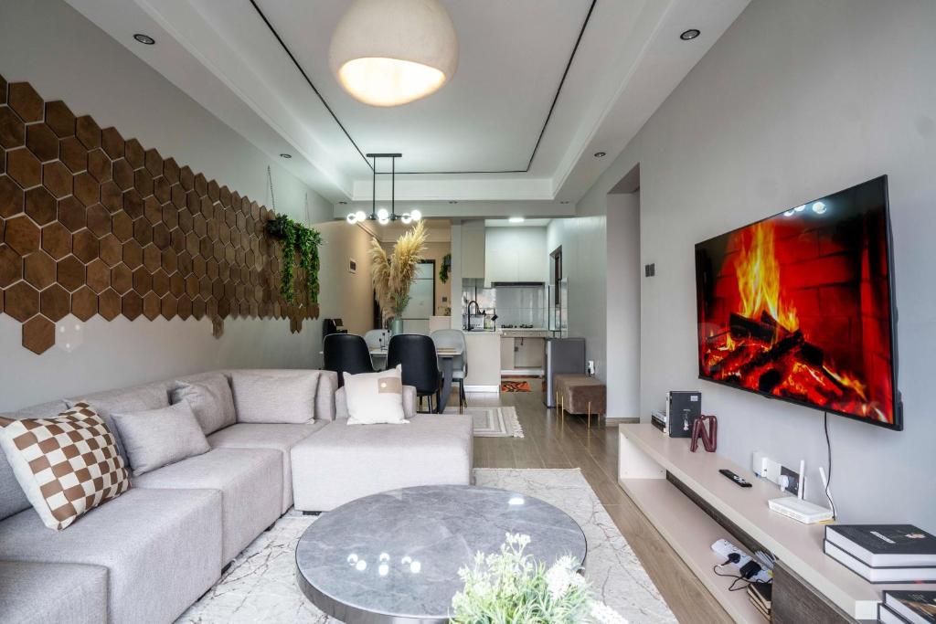 a living room with a couch and a table at Oak Classic Residence in Nairobi