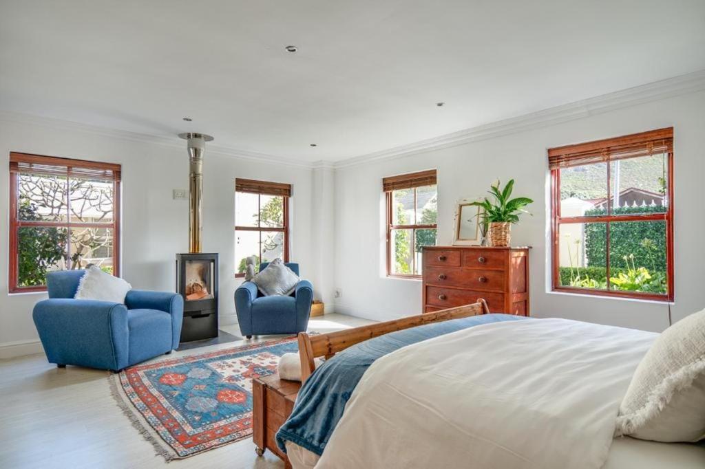 a bedroom with a bed and two chairs and a fireplace at #5A on Brassie in Lakeside
