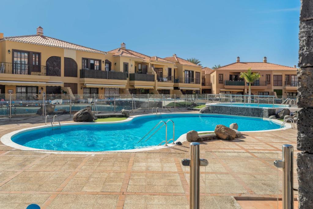 a large swimming pool in front of a building at Viva Tenerife in Costa Del Silencio