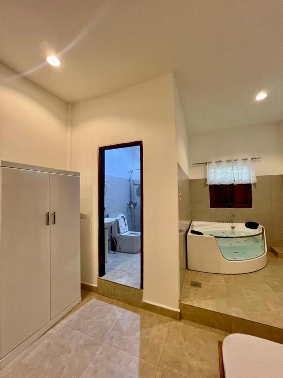 a bathroom with a bath tub and a mirror at Mkunazini Heritage Center in Zanzibar City