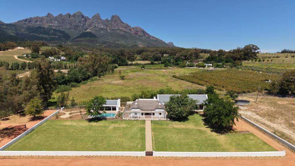 an aerial view of a house with mountains in the background at Villa Canetsfontein in Wellington