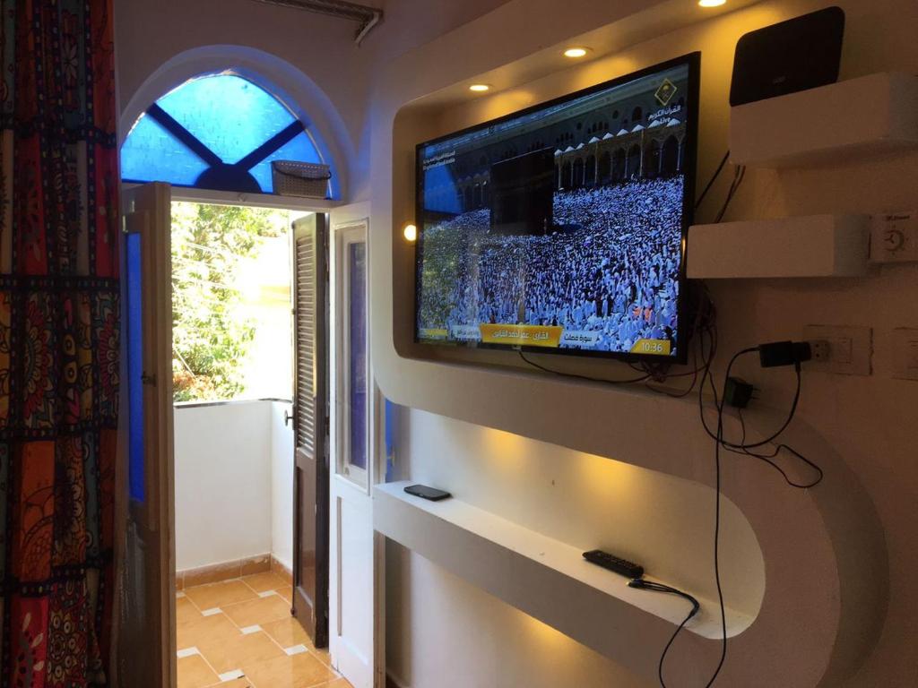 a television hanging on a wall in a room at Gana kato in Aswan