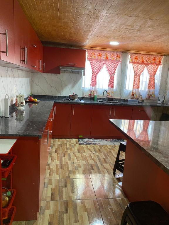 a kitchen with red cabinets and a counter top at House in Molina in Molina
