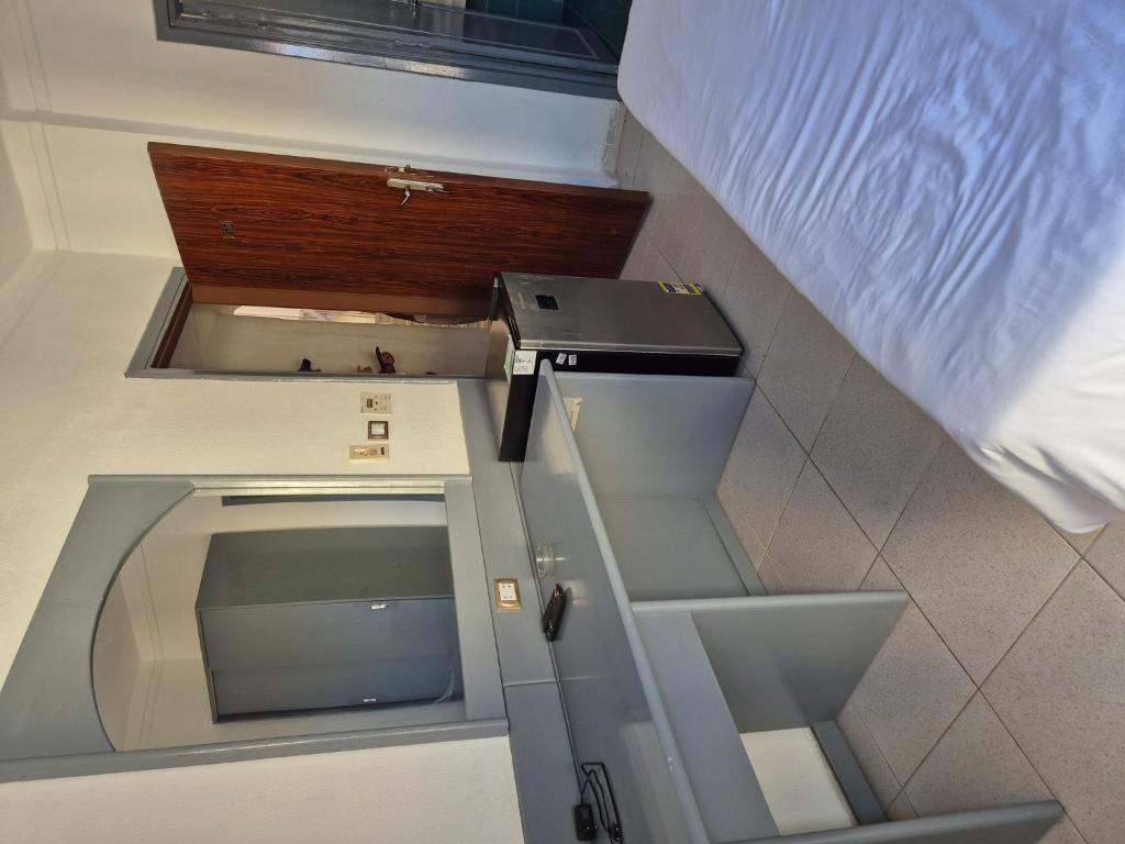 a small room with a bed and a window at Elixir Hotel Hurghada 2 in Hurghada