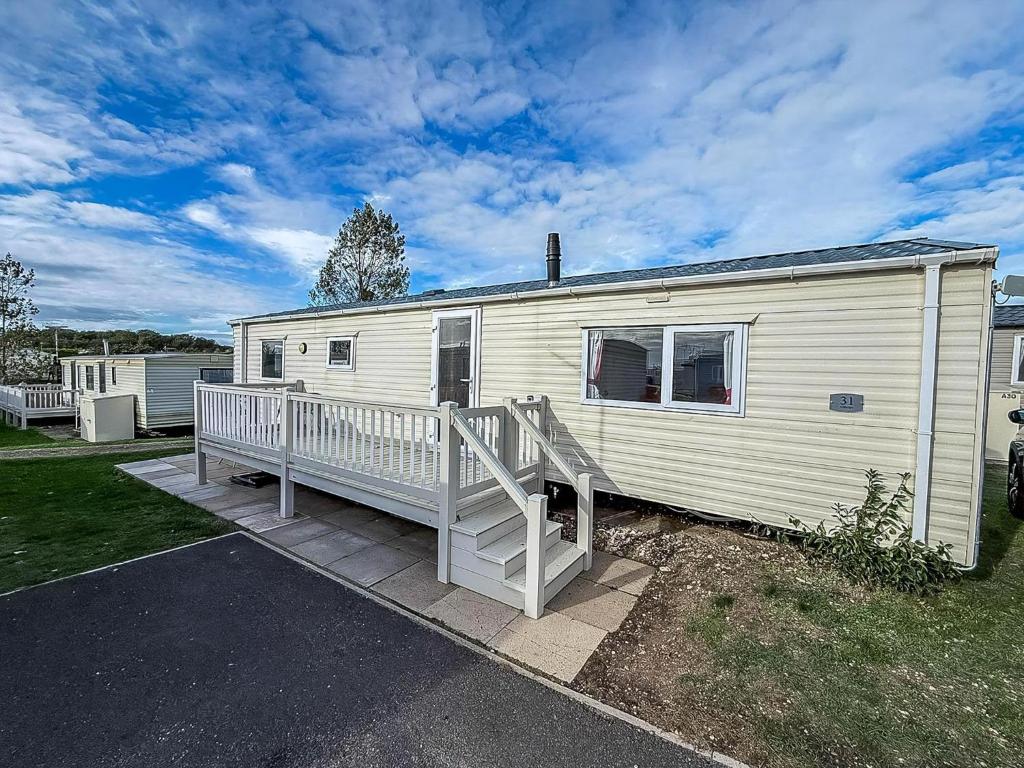 a white mobile home with a porch and a house at Brilliant 6 Berth Caravan With Decking At Heacham Beach Park Ref 21031A in Heacham