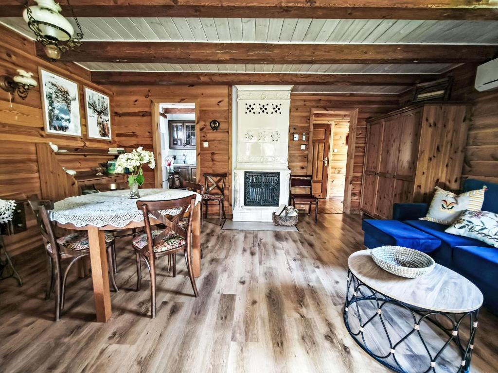 a living room with a table and a blue couch at Apartment Julia by Interhome in Stoczek