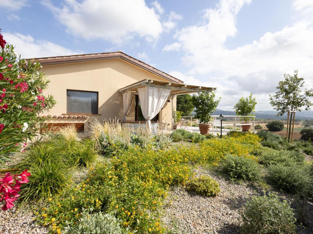 a house with a garden with flowers at Holiday Home Poggio Piero 1 by Interhome in Montemassi