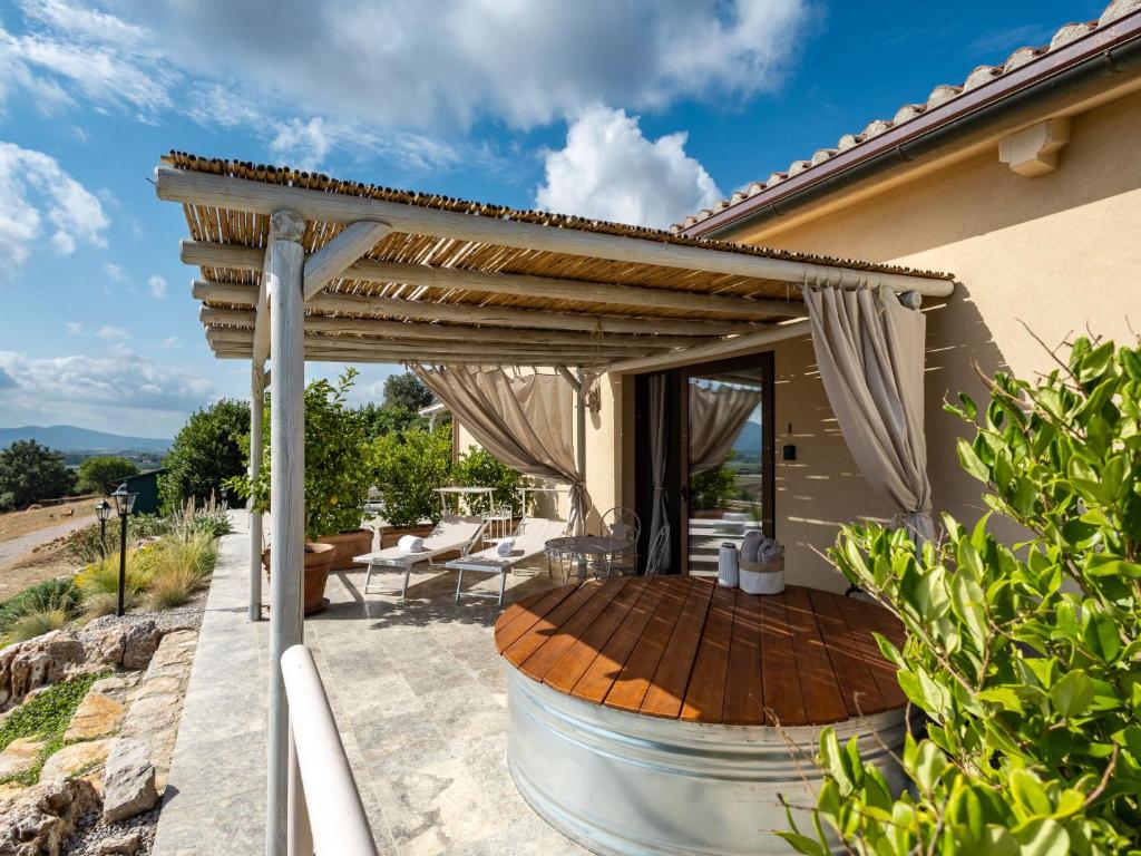 a wooden pergola on a patio of a house at Holiday Home Poggio Piero 2 by Interhome in Montemassi