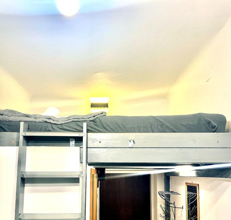 two bunk beds in a room with a ceiling at Tiny Studio in Graz
