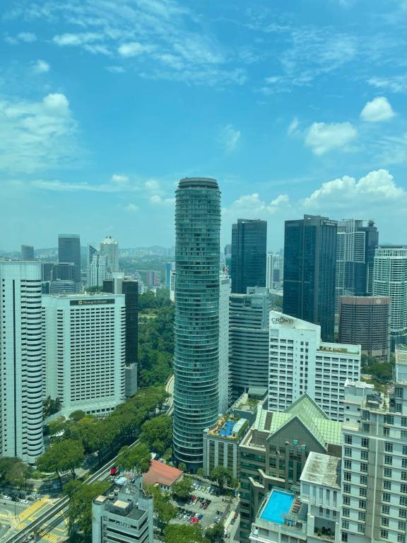 a view of a city skyline with tall buildings at vortex KLCC YOUR HOME in Kuala Lumpur