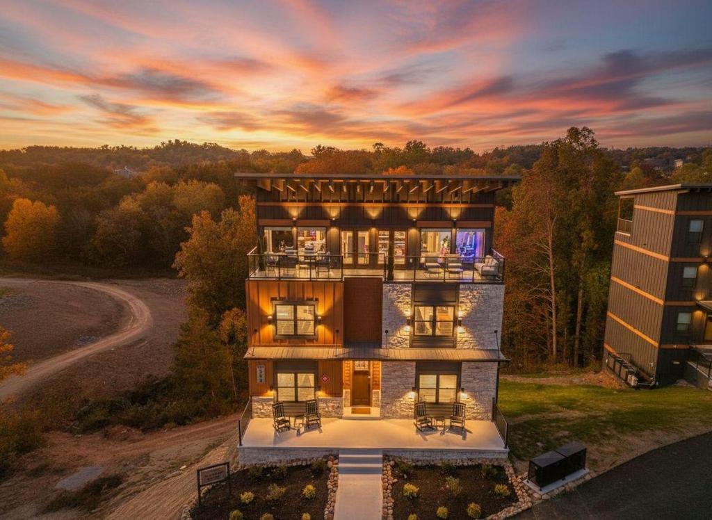 an aerial view of a house with a sunset at The Great Escape! Sleeps 26 - Sky Deck - Arcade - Golf - Waterpark in New Era