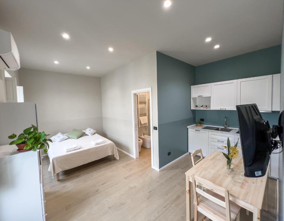 a kitchen and a living room with a table in a room at Top Rooms Torino in Turin