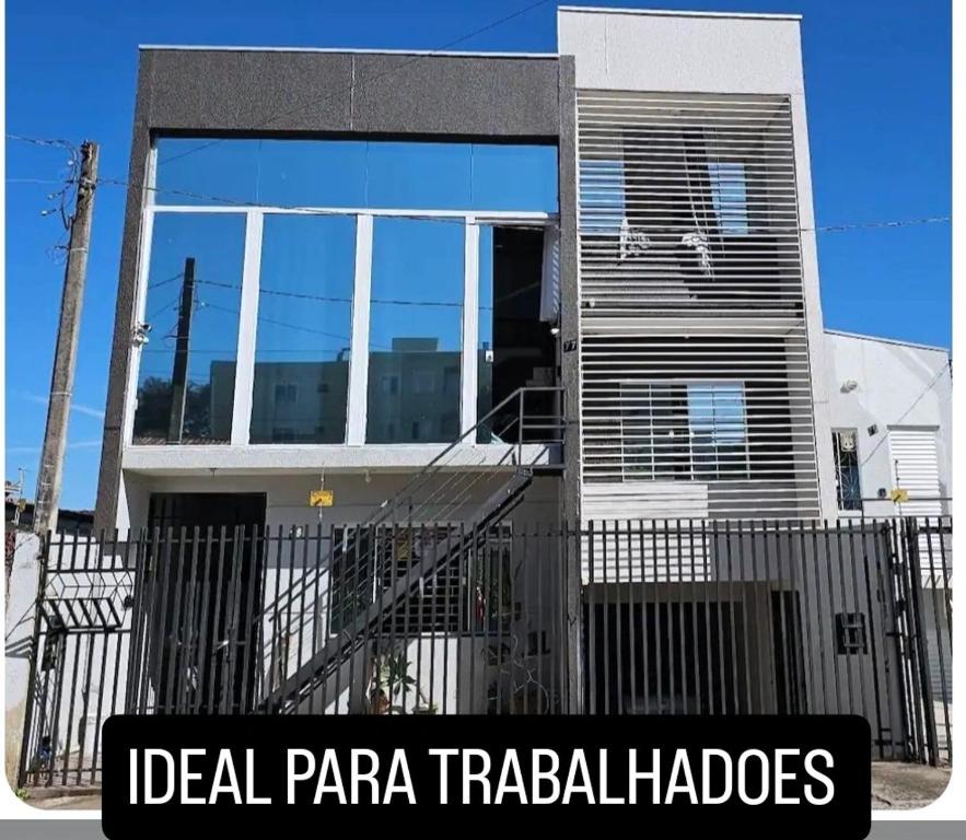 a house with a fence in front of it at kitnet central com linda vista 75 in Ponta Grossa