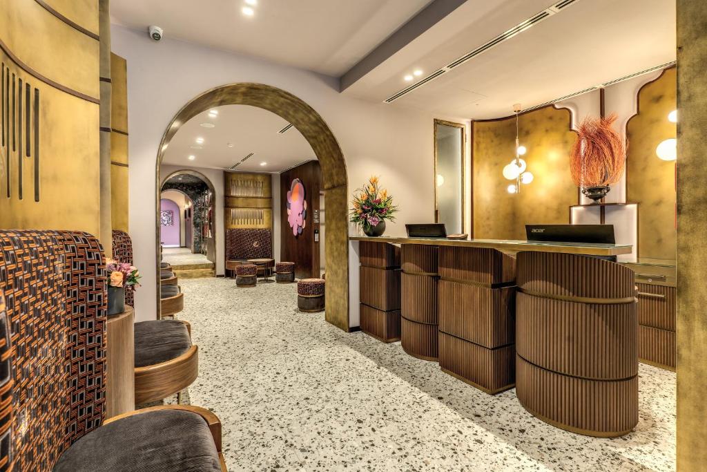 a lobby with a bar with stools at THE STEPS Hotel - by Eitch Collection in Rome