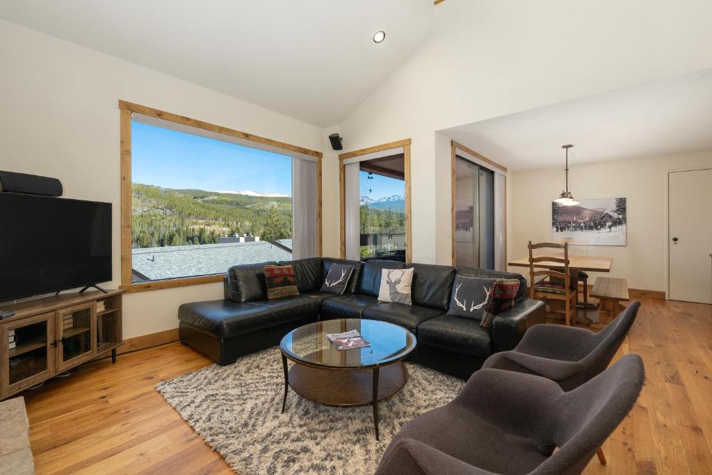 a living room with a black couch and a tv at Snowblaze Condos Building A unit 33 in Winter Park