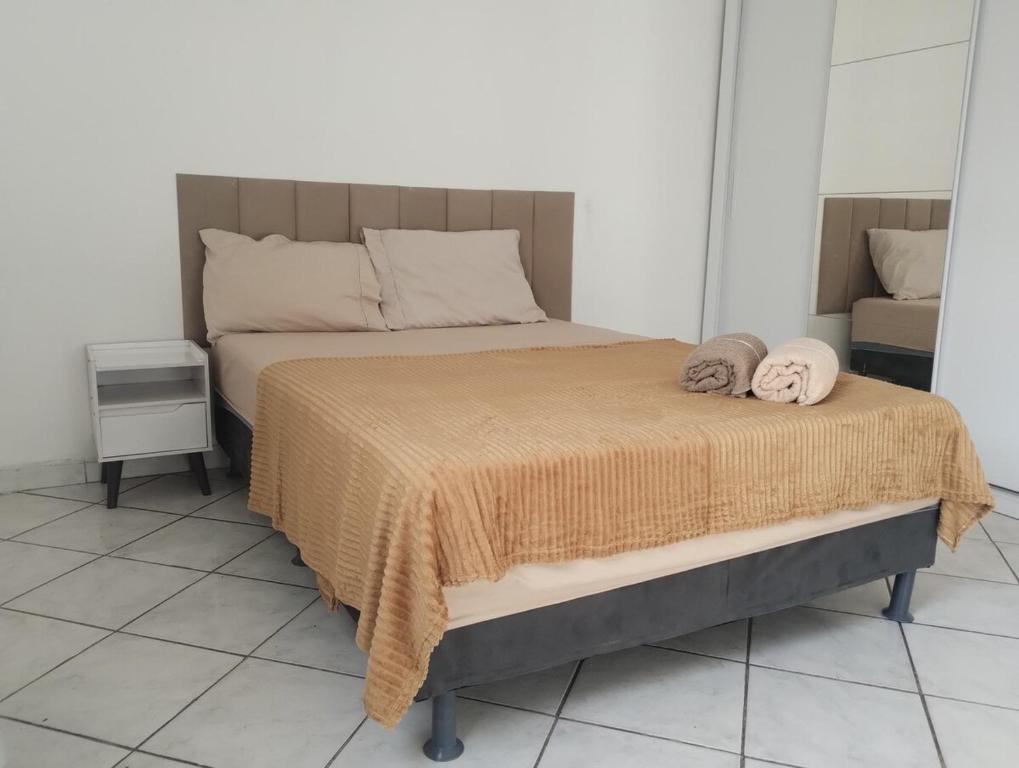 un lit avec deux oreillers dessus dans une chambre dans l'établissement AP Custo benefício a 10 min de praia,rodoviária, estádio e ferroviária, à Vila Velha