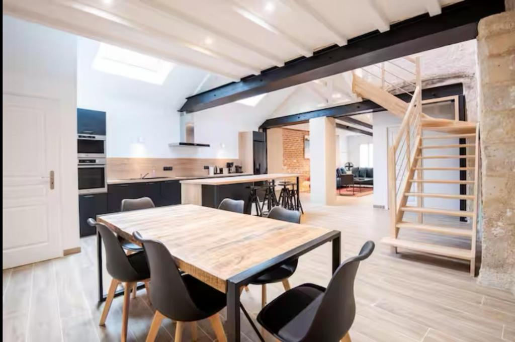 a kitchen and dining room with a wooden table and chairs at La Maison Renaissance Amboise 4 bedroom house in Amboise