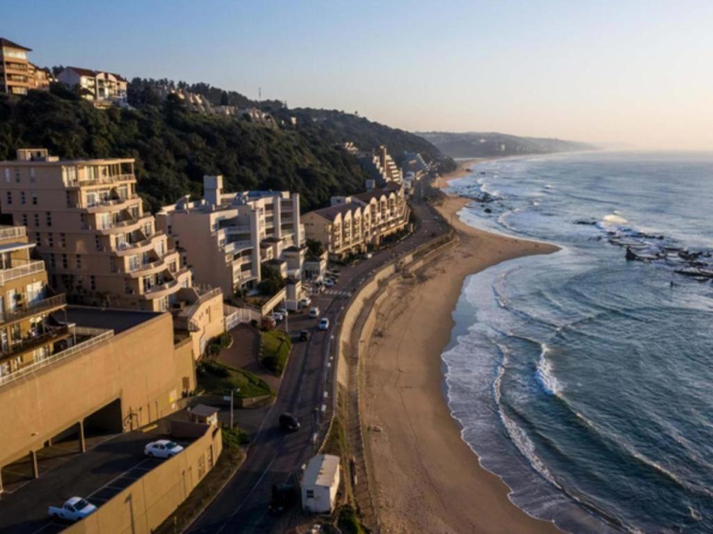 an aerial view of a beach with buildings and the ocean at Umdloti Beach Unit in Umdloti