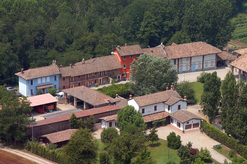 an aerial view of a group of houses with trees at Agriturismo Cascina Caremma in Besate
