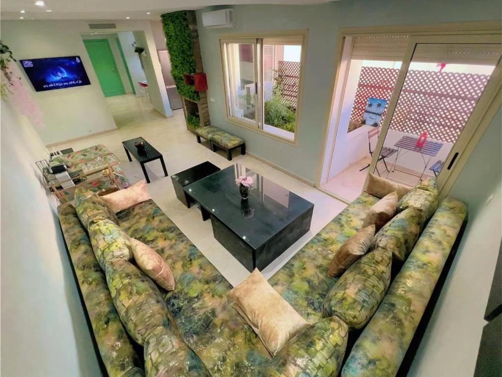 Una sala de estar con un sofá grande y una mesa. en Ibiz Appartement, en Casablanca